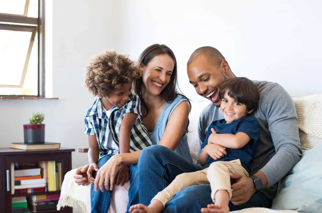 happy family smiling woman and man with two young children